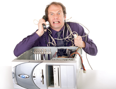 IT Guy shakes hands with a client in front of a comms cabinet