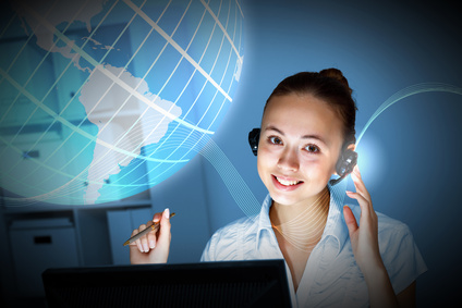 two girls, one with receiptionist's headset, look at the screen