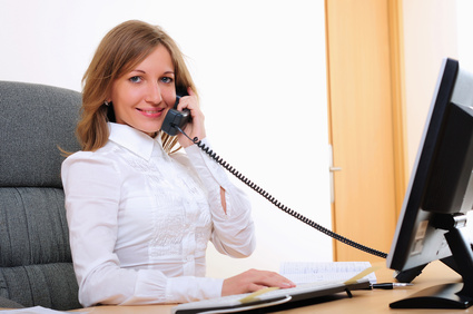 smiling woman with telephone handset to her ear